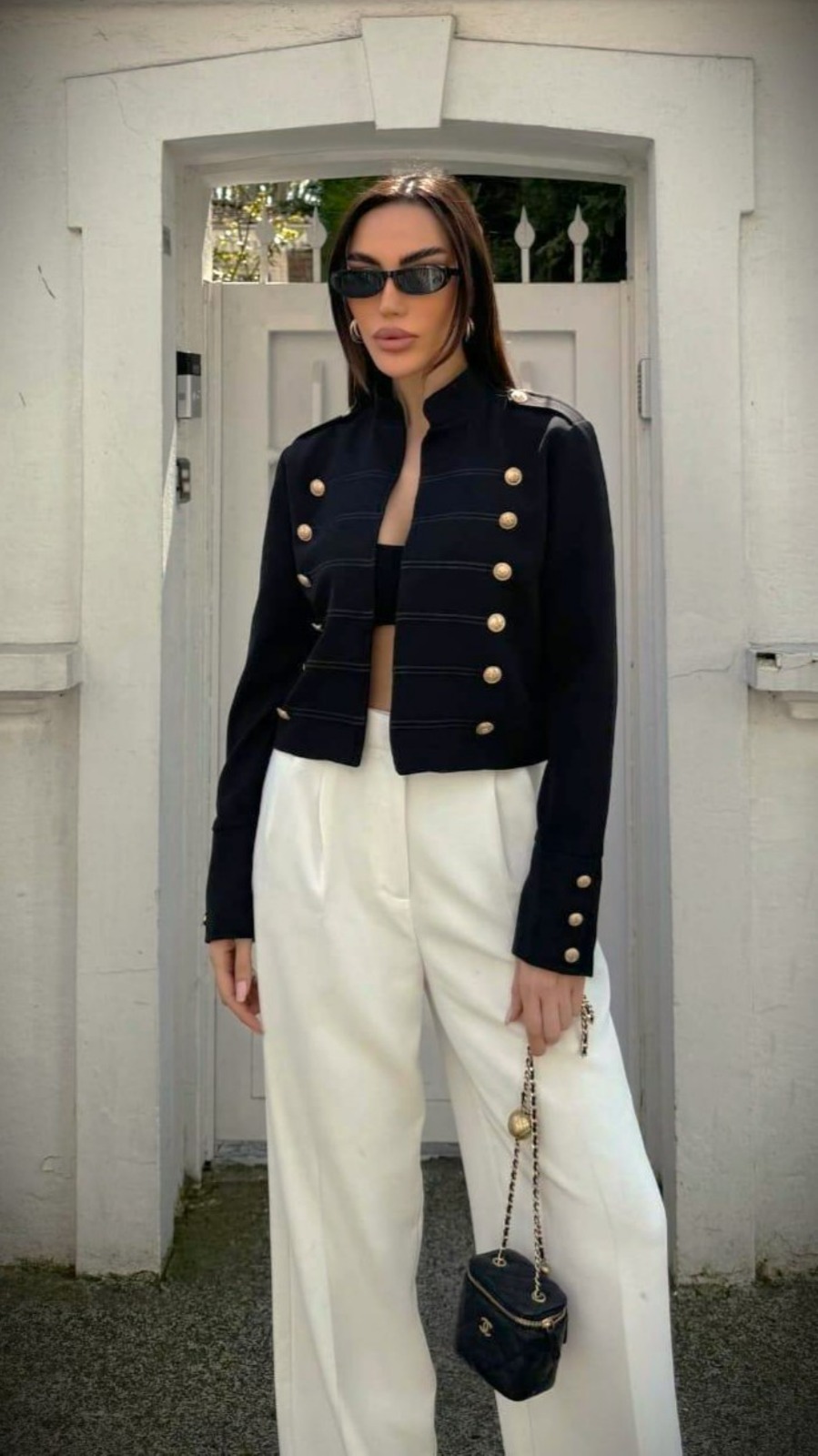 Navy military-inspired jacket with white trousers from Rhyme & Hype
